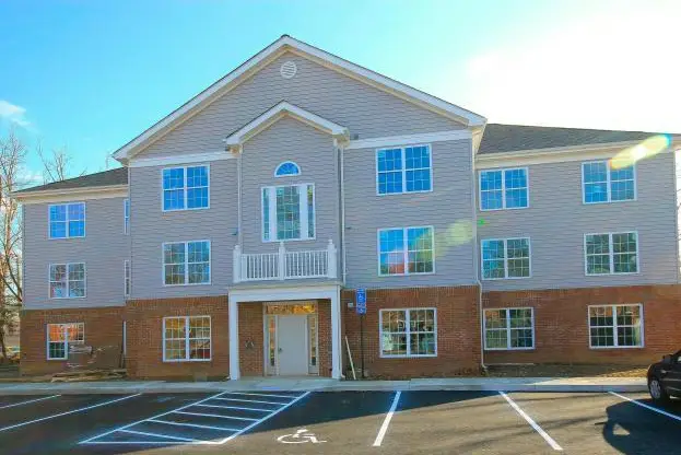 Building exterior photo of Perry Hall, a condo building located on Columbia Pike in Arlington, VA.